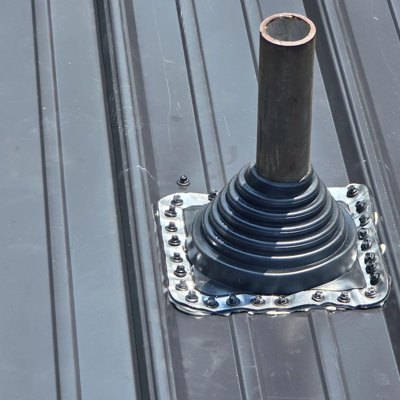 Roof Penetration Flashing Detail — St. Louis Cost Guide Close view of a flashed pipe penetration on a standing-seam metal roof