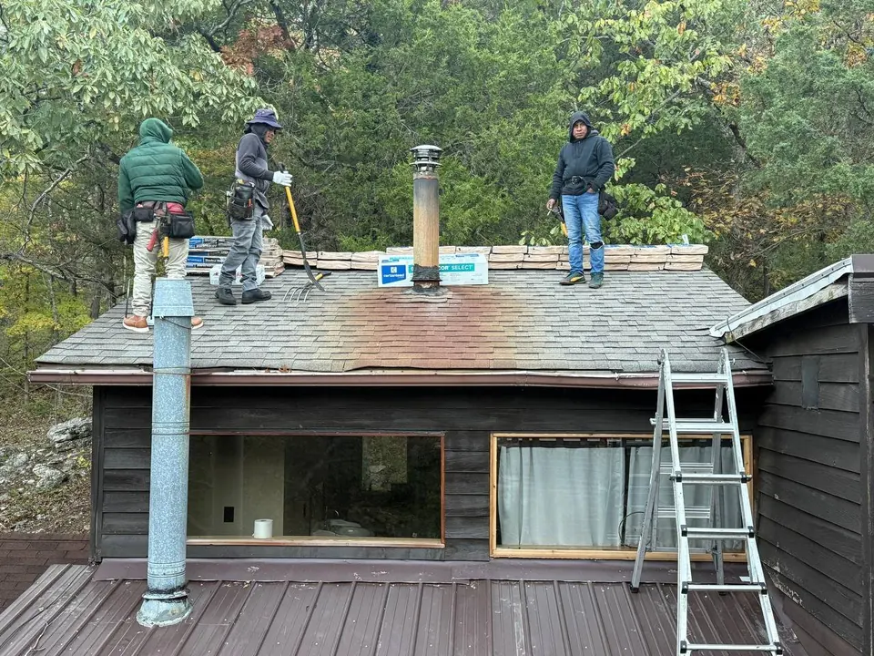 Roofing Crew and Material Staging — Roofing COP Guide Roofing crew standing on an existing shingle roof beside staged materials