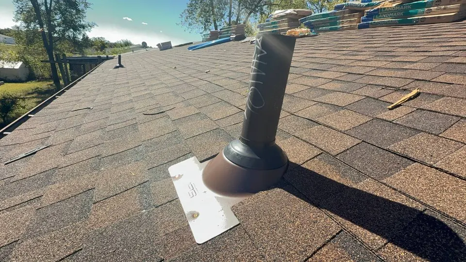 Vent Pipe Flashing Detail — Roofing COP Guide Vent pipe flashing on a shingle roof with roofing materials staged nearby